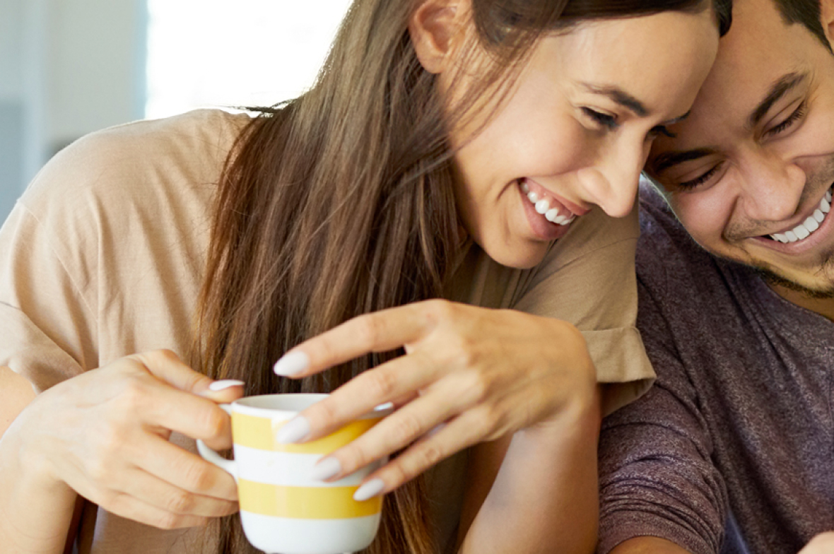 Couple smiling drinking tea