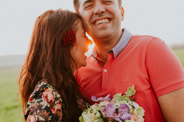 Couple smiling with flowers